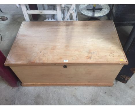 An Antique stripped wood trunk with integral candlebox