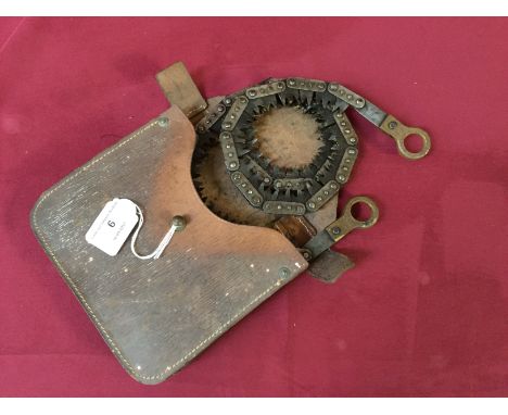 A Vintage hand chain saw, in leather carrying case
