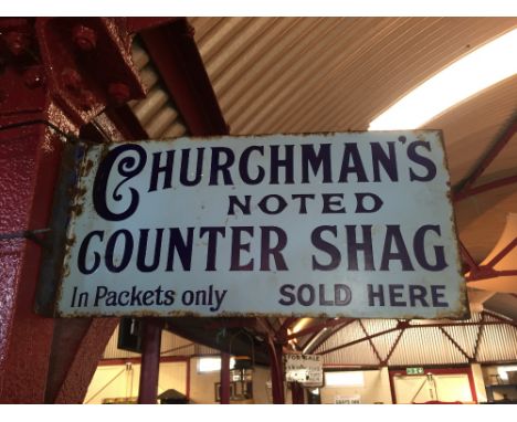 An enamel double sided advertising sign for "Churchman's Noted Counter Shag", (approx. 46cm x 23cm)