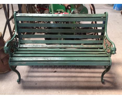 A garden bench with lion head cast ends