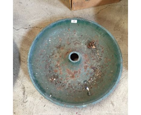 A circular cast iron pig trough