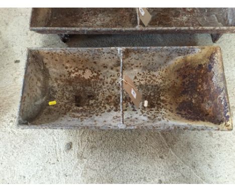 A small cast iron two section pig trough
