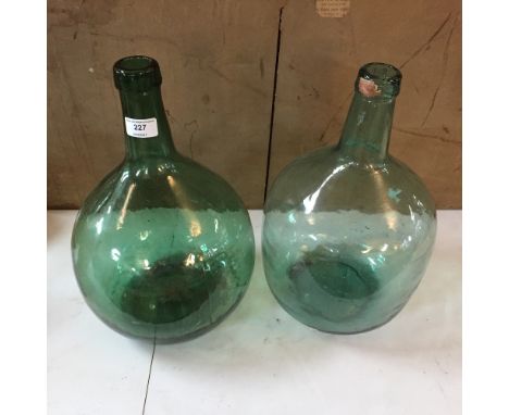 Two green glass Vintage bottles of bulbous form