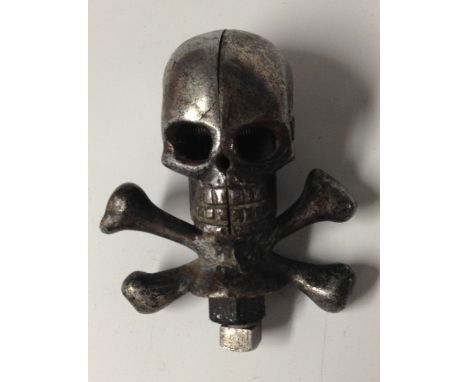 A novelty cast steel skull and cross bones car mascot, 9cm high 
