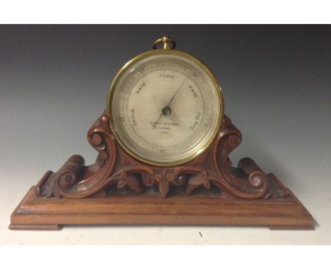 A Victorian brass aneroid desk barometer, the 11.5cm diam silvered dial inscribed Negretti and Zambra/London/11152, brass dru