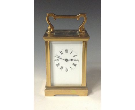 An early 20th century French lacquered brass carriage clock, 4.5cm white enamel dial, Roman numerals, swing handle, marked F 