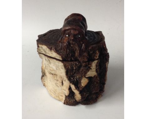 An unusual Black Forest silver birch novelty tobacco jar, the hinged  cover carved with with a disgruntled gnome, peering ove