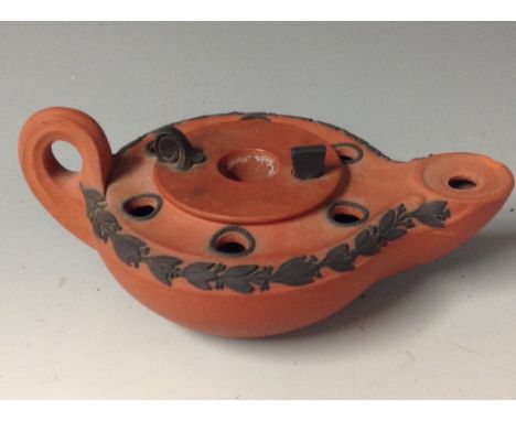 A Wedgwood Rosso Antico oil lamp, of typical form, modelled after the antique, applied with bands of leaves and sprigs in gre