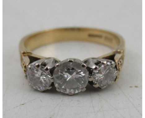 An 18ct three stone diamond ring, the centre stone estimated weight 0.42cts estimated weight  0.020 each, Birmingham 1984, we