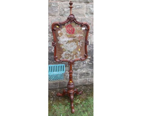 A 19th century mahogany pole screen, with tapestry panel of flowers, height 59ins&nbsp;