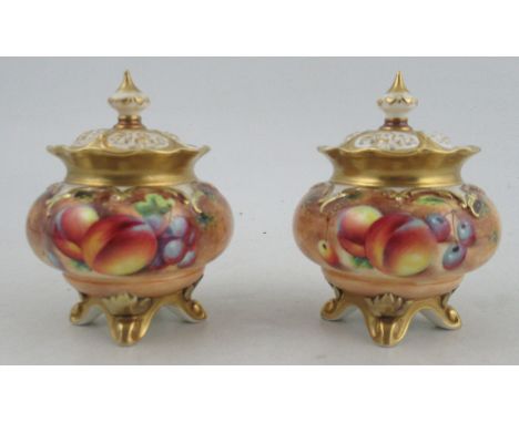 A pair of Royal Worcester covered vases, decorated all round with fruit to a mossy background by Roberts, shape number H261, 