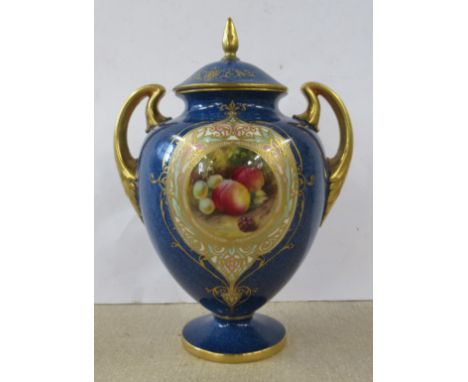 A Royal Worcester covered pedestal vase, decorated with a circular reserve of fruit by Moseley, to a gilt and coloured frame 