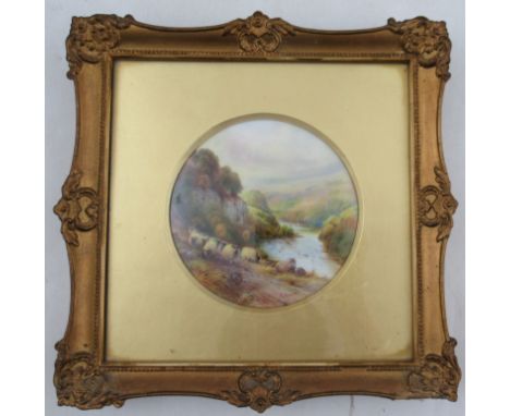 A Royal Worcester circular porcelain plaque, The Eden Near Carlisle, decorated with a flock of sheep walking along a path of 