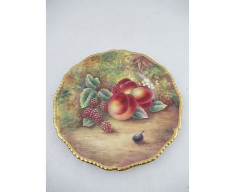 A Royal Worcester plate decorated with hand painted fruit by James Skerritt to a shaped gadrooned boarder diameter 10.5ins&nb