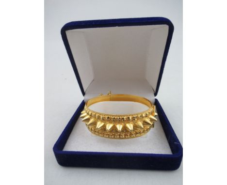 A yellow gold hinged bangle with spiked frieze ,unmarked approx 6cm diameter, 26.8g (untested) estimated 22ct&nbsp;