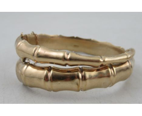 A 9ct simulated hinged bamboo bangle, of overlapping and tapered form, weight 24.2g