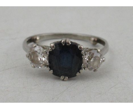 A diamond and sapphire three stone ring, oval-cut sapphire to the centre and two round cut brilliant diamonds each approx 0.3
