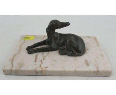 A bronze model, of a recumbant dog, on marble base, height 2ins