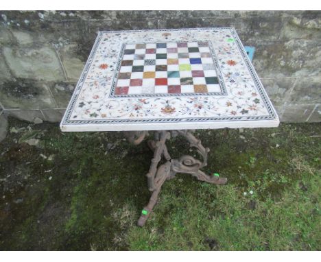 A rectangular marble or alabaster chess board inlaid with various marble and agates to a floral boarder 22ins x 22ins raised 