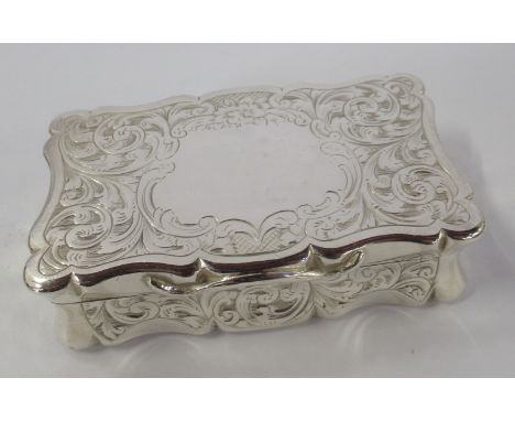 A 19th century silver snuff box, of shaped rectangular form, engraved with scrolls and flowers, vacant cartouche, Birmingham 