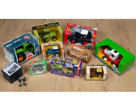 A collection of boxes toy tractors comprising a Steiger die-cast panther ST310; a Ford die-cast TW20; an International die-ca