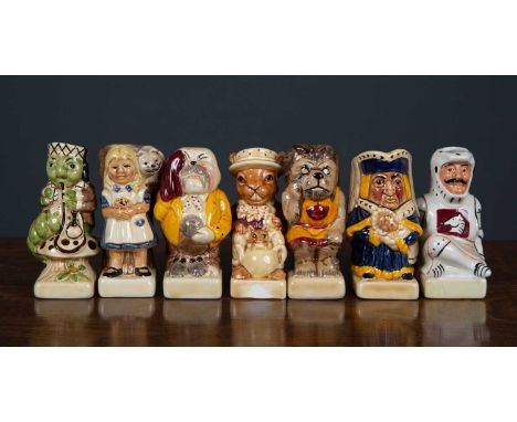 A set of fifteen Alice in Wonderland themed miniature toby jugs, including the Mad Hatter, the Jabberwocky and Tweedledum and