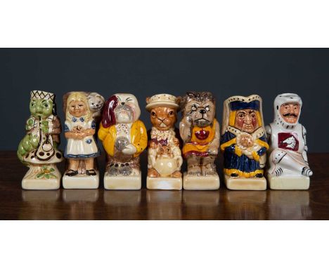 A set of fifteen Alice in Wonderland themed miniature toby jugs, including the Mad Hatter, the Jabberwocky and Tweedledum and