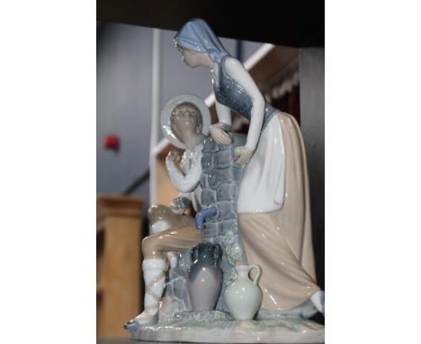 LARGE NAO FIGUREof a girl and boy eating grapes by a water tap, 31cm high