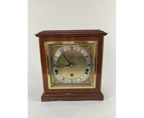 A mahogany cased Elliot mantle clock, the 5 1/2 inch square gilt dial with cherub spandrels, marked Garrard &amp; Co Ltd, Lon