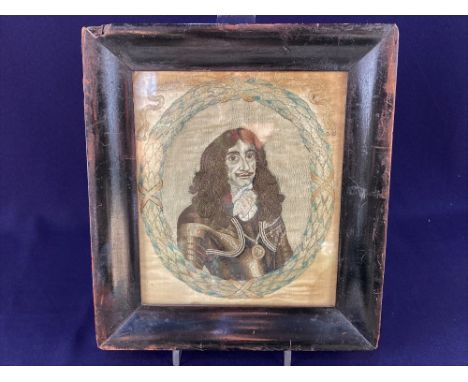 A embroidered panel depicting an oval miniature portrait of Charles II within a wreath of leaves, 19cm by 15cm, in glazed fra