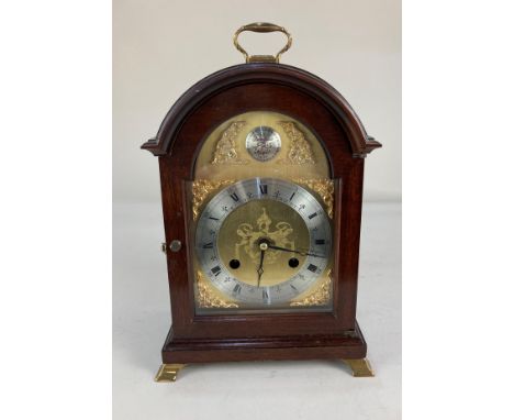 A modern reproduction mahogany cased bracket clock, the domed gilt face with silverised dial marked Comitti of London, made i