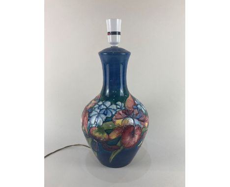 A Moorcroft pottery table lamp in the orchid pattern on blue ground, 40cm high