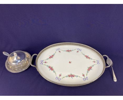 A porcelain oval serving tray, decorated with floral swags and ribbons with pierced metal mounted gallery and two handles, 45