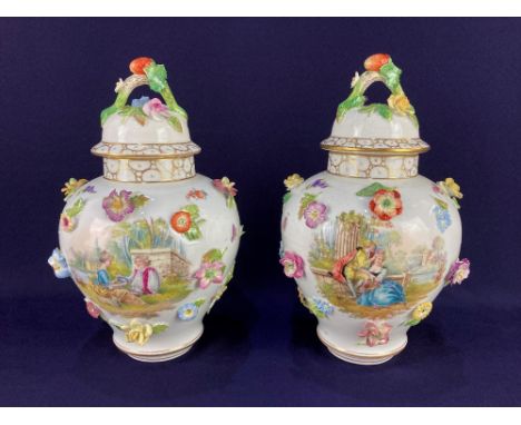A pair of Dresden porcelain vases and covers, of baluster form, with applied flowers, and scenes of lovers amongst flowers an
