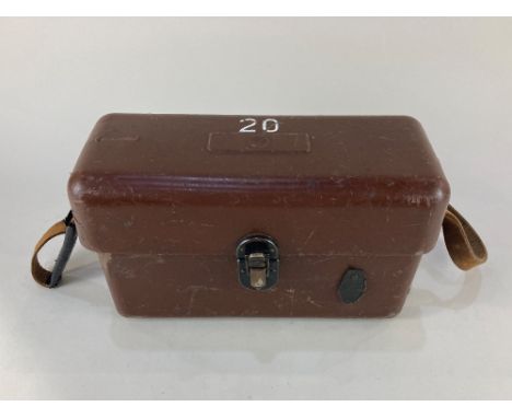 A field telephone, with rotary dial, in hard plastic case with leather strap, possibly military, 27.5cm wide