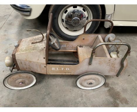 A toy fire engine pedal car for restoration. 