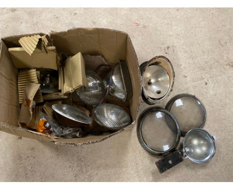 A box of lamps, sealed beam including VW Beetle lenses and shells. 