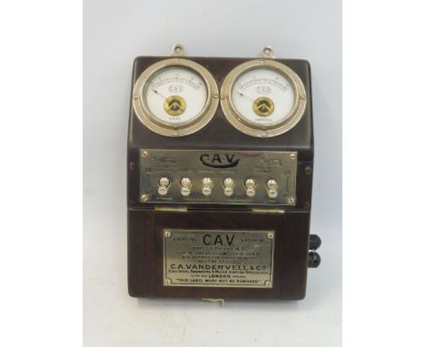 An Edwardian CAV bulkhead mounted switch panel, showing a voltmeter adjacent to an ammeter, above a nickel plated lighting sy