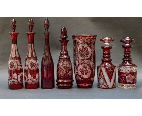 Six Bohemian ruby flashed decanters and stoppers, together with a vase