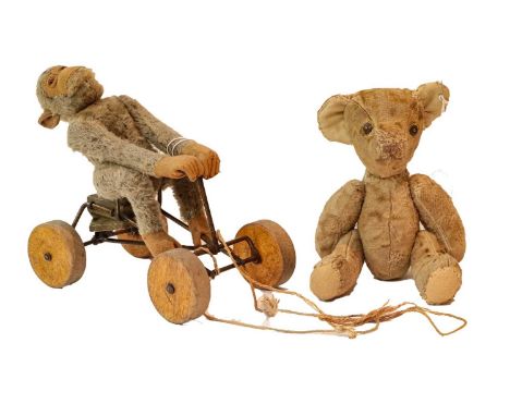 A Steiff pull along grey monkey 'Jocko' on a bike with four wooden wheels and metal frame (no button), and a jointed teddy be