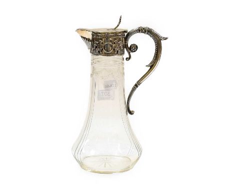 A cut-glass claret jug with Continental white metal mounts, stamped 800, and decorated with griffin, 28cm high