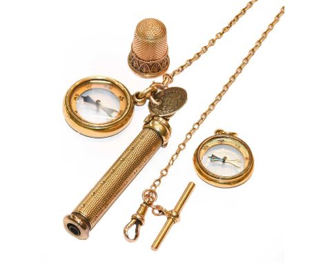 A gilt propelling pencil, on a chain with a compass pendant and coin attached; together with another compass pendant; and a t