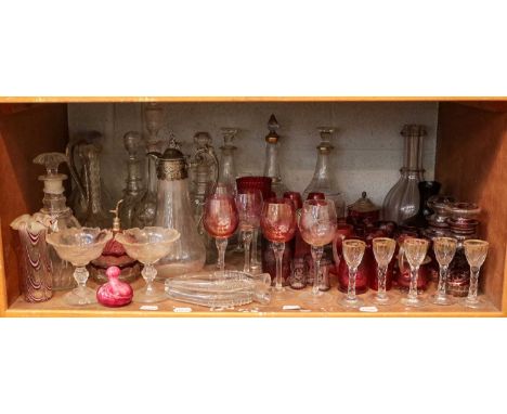 ~  A large quantity of glass including Bohemian and cranberry items, decanters, Nailsea double flask, claret jug with silver 