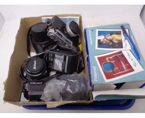 A tray of Nikon and Yashica cameras, together with accessories and further boxed Polaroid camera 
