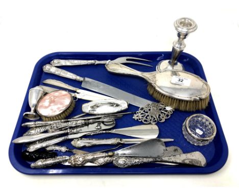 A tray of silver ware including weighted silver candlestick, dressing table items, silver mounted button hooks and shoe horns