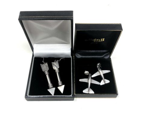 A pair of silver arrow earrings, together with a pair of similar aeroplane earrings. 