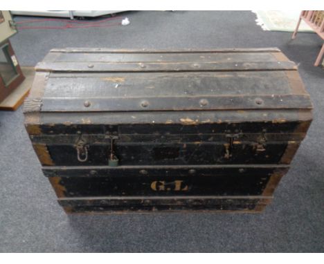 A Edwardian wooden bound dome topped shipping trunk, height 53 cm, width 76 cm, depth 47 cm.