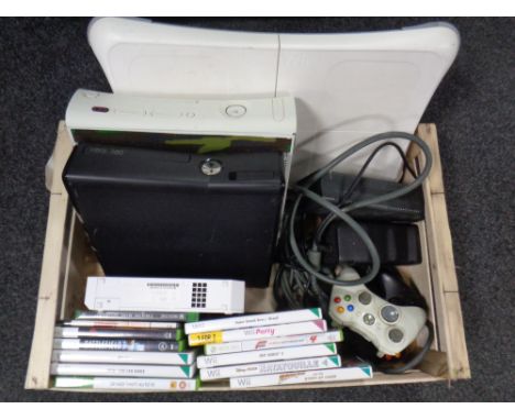 A box containing 2 Xbox 360 consoles with leads and accessories, Nintendo Wii console with Wii Fit board together with assort