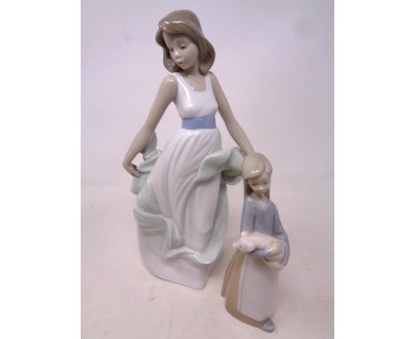 Lladro figure of a girl holding a piglet together with a Nao figure of a girl in dress 