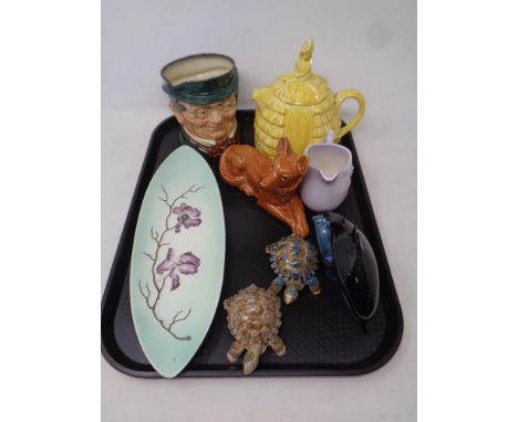 A tray of assorted ceramics to include Royal Doulton Mr Pickwick Toby jug, Poole dolphin, Carlton ware, Wade tortoises etc 